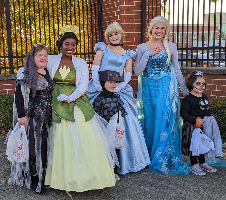 Princesses pose with children at Rockin' Trick or Treat 2022